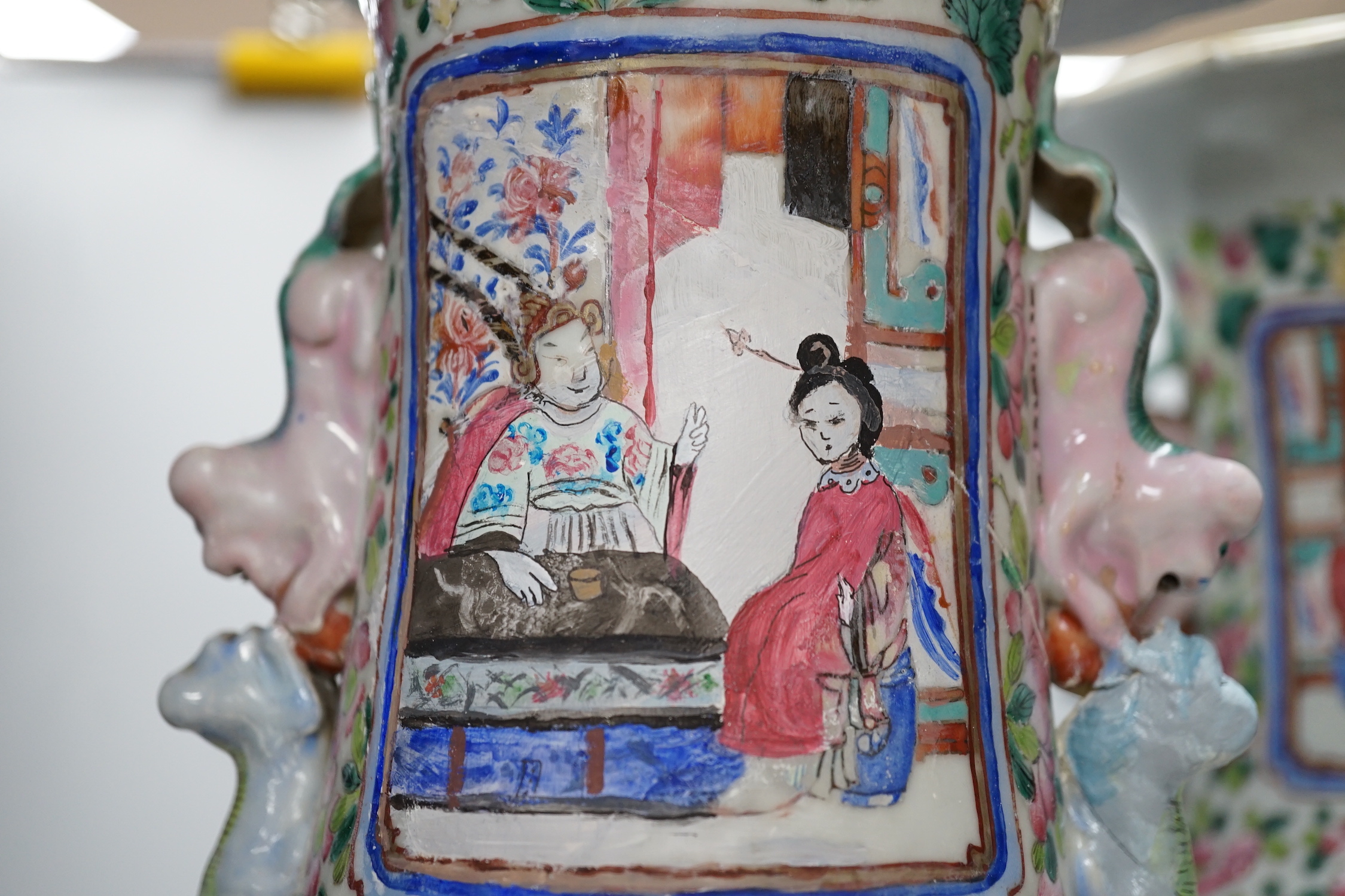 A pair of large Chinese porcelain famille rose vases, 19th century, decorated with court scenes and flowers, 61cm high